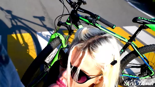 Busty tattooed blonde gets so aroused during a bike ride that she gives a passionate blowjob in the middle of an intersection